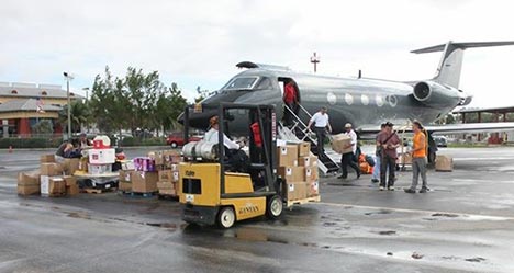 forklift loading supplies into aircraft