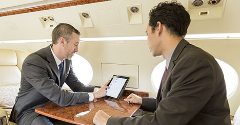 two men in cabin with e-notepad