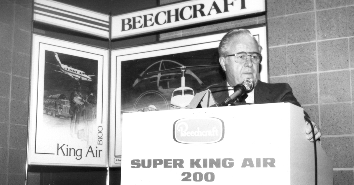 Speaker at podium with Beechcraft displays