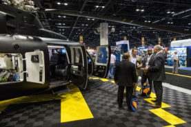 Attendees and exhibitors interact at an exhibit at the Indoor Static Display