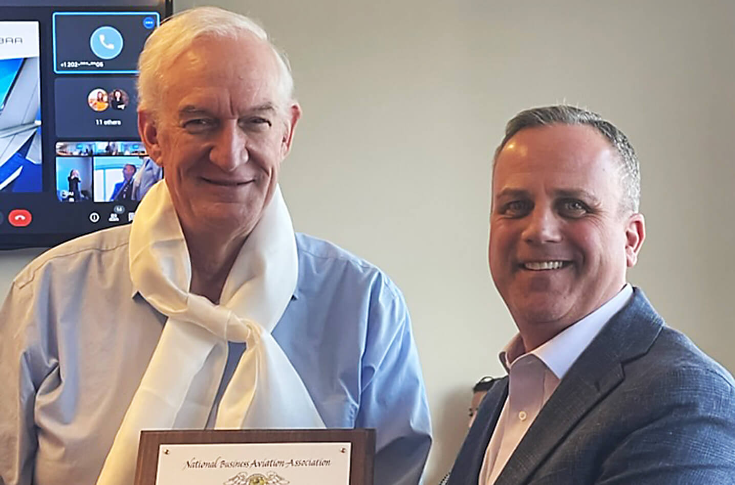 Bob Searles (left) is presented with the Silk Scarf Award by Dan Hubbard, senior vice president, communications